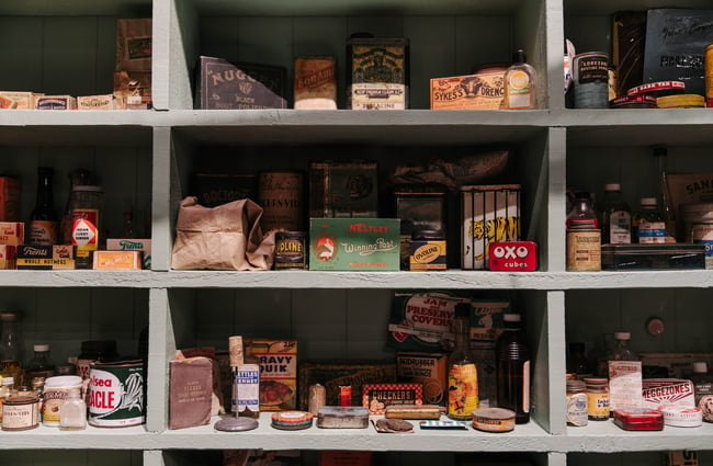 Old tins and old food packaging on shelves at Kaikōura Museum.