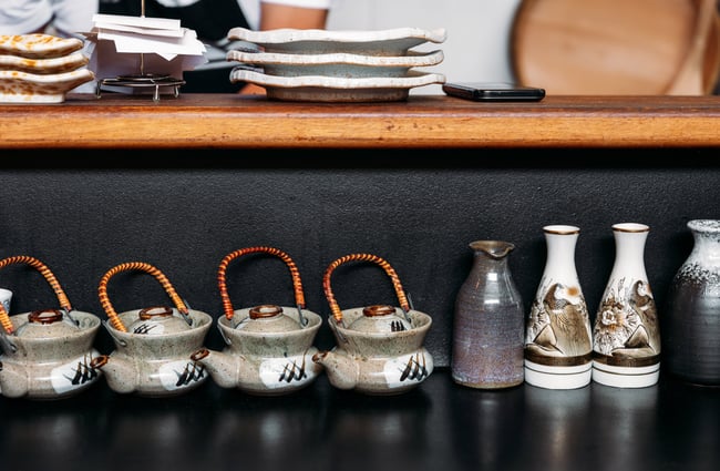 A close up of teapots and bottles.