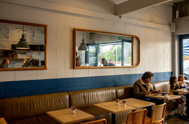 A blue and white painted wall inside Kepa Road Cafe.