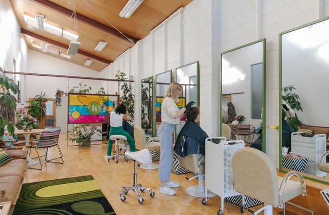 Hairdressers cutting clients' hair in Kin Hair.