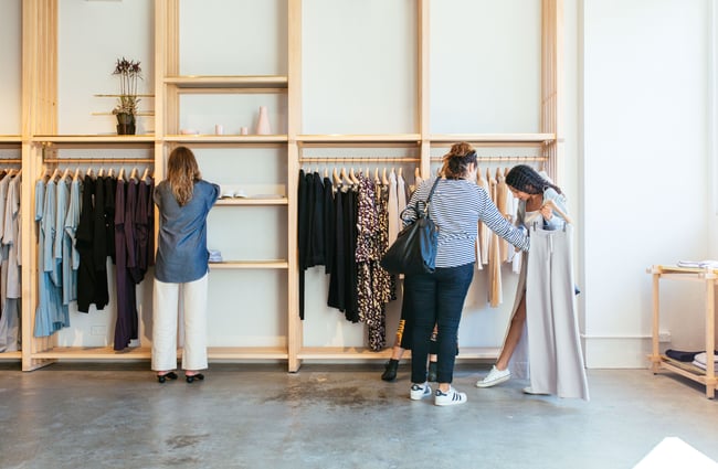 Two women looking at clothes inside Kowtow Wellington clothing store, New Zealand.