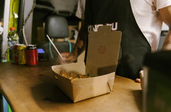 Box of takeaway food on the counter of the food truck.