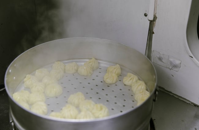Dumplings being steamed inside Kung Fu Dumplings food truck.