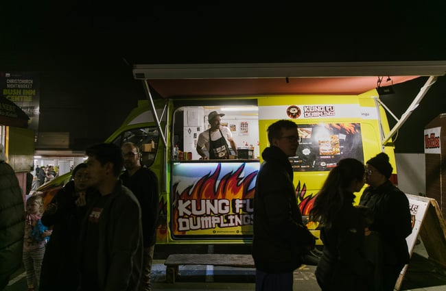 People standing outside Kung Fu Dumplings food truck.
