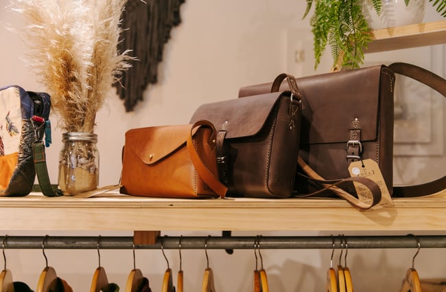 Leather handbags on a shelf at Little Beehive Co-op.
