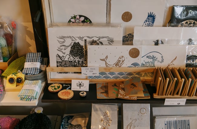 Prints of whales on a table at Little Beehive Co-op.