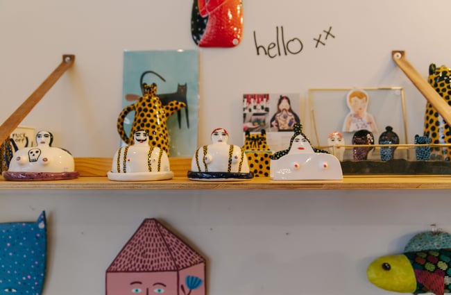 Quirky ornaments on a shelf at Little Beehive Co-op.
