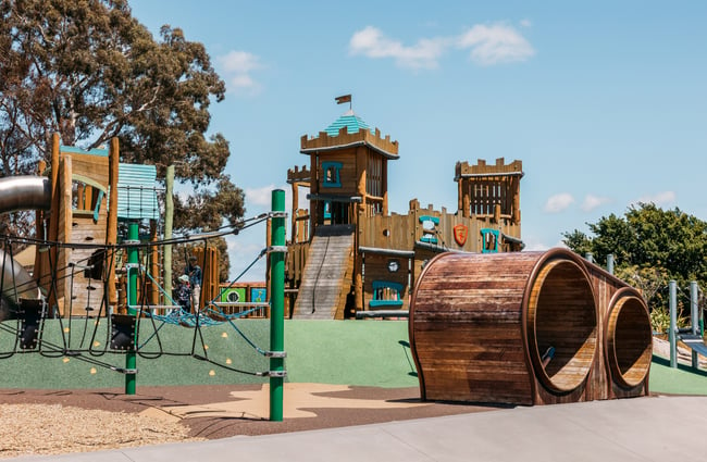A large outdoor playground on a sunny day.