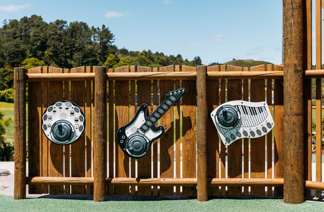 Musical instruments on a wooden fence.