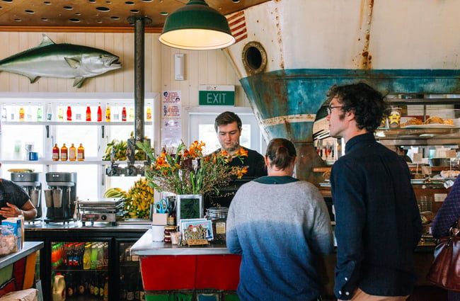 People being served at the counter of Maranui cafe Wellington.