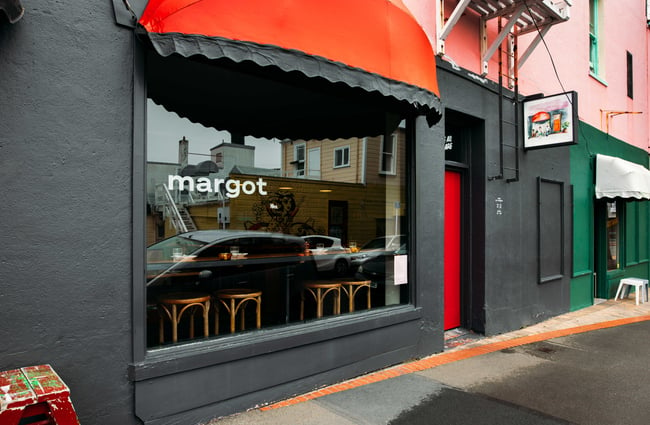 The black exterior of Margot restaurant from the street.