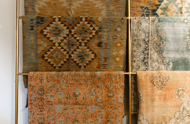 An extreme close up of old rugs on display.
