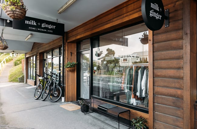 The wooden and black exterior of Milk and Ginger store.