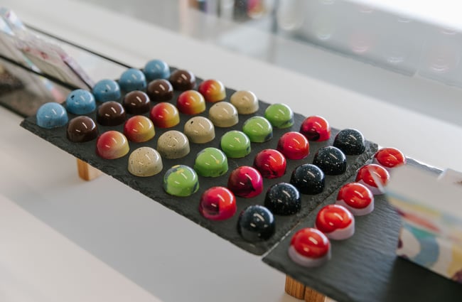 A close up of colourful chocolates on display at Mind Your Temper Christchurch.