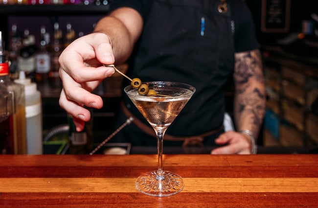 A close up of a martini on a bar.