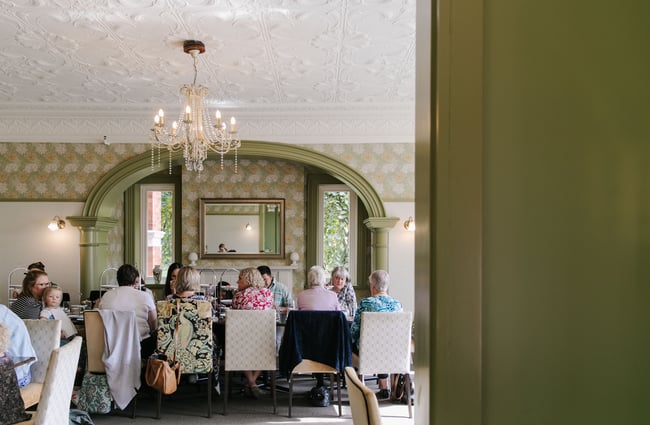 Table of customers having afternoon tea at Mona Vale in Christchurch.