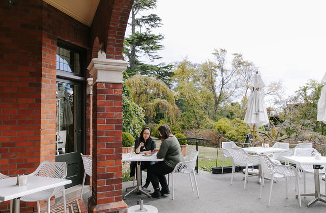 Two woman outside dining at Mona Vale in Christchurch.