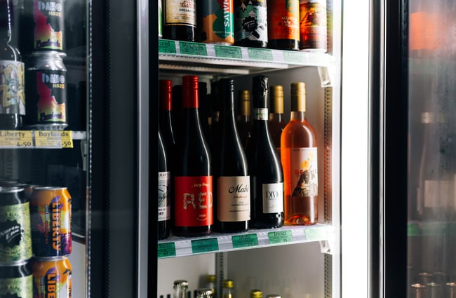 Open fridge door showing chilled white wine and bubbles at Monkfish, Wellington.