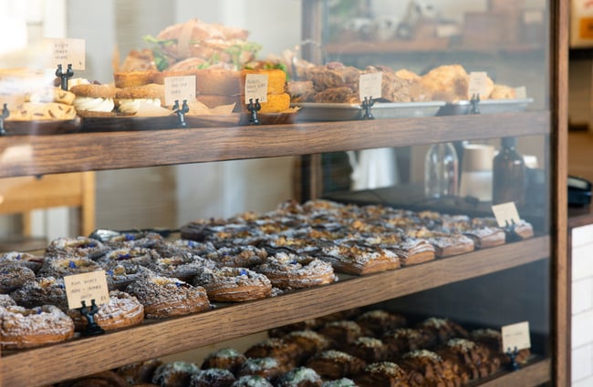 Pastries and biscuits in a glass counter in a cafe.