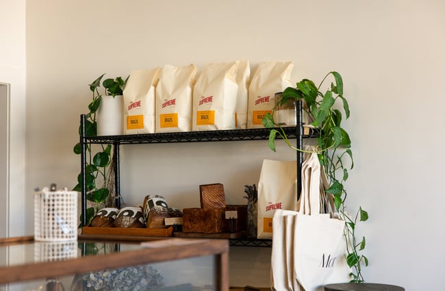 Bags of coffee beans and bags on display for sale at Mor Bakery in Auckland.