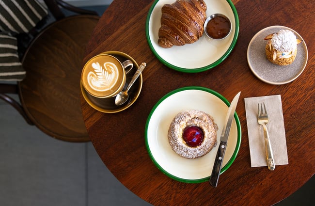 A flatlay of pastries and coffee on a table.