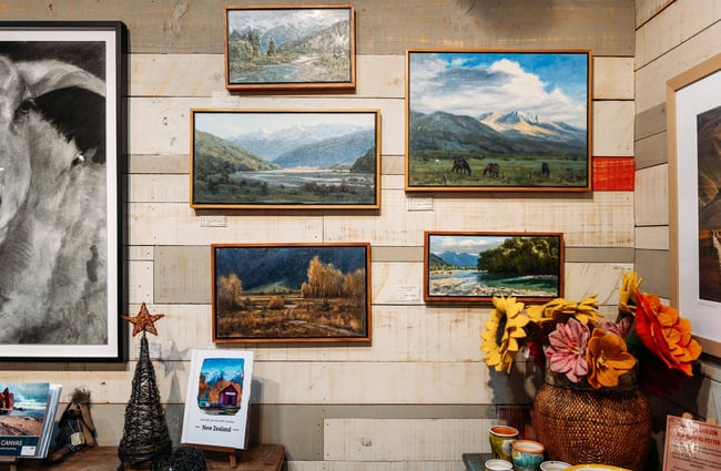 Landscape paintings on a wall.