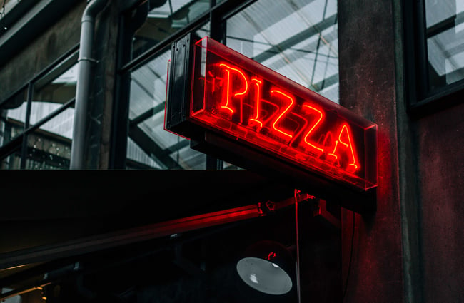 Neon pizza sign at Ms White, New Plymouth.