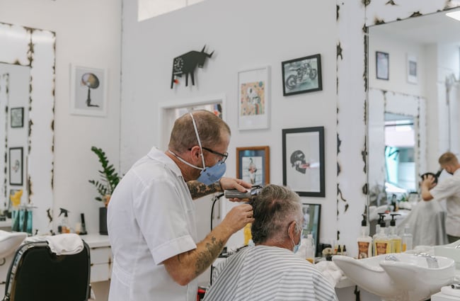 Barber cutting a man's hair at New City Barbers in Christchurch.