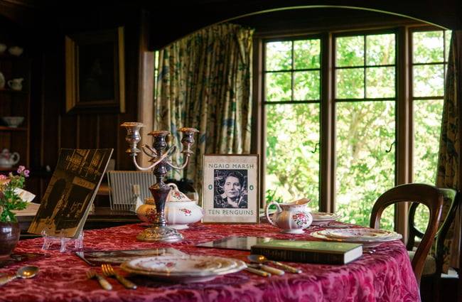 A portrait of Ngaio Marsh House on an old table setting.