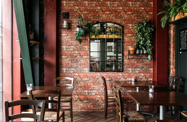 A brick wall inside a light and bright wine bar in Wellington.