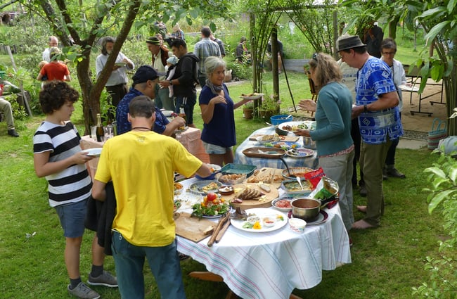 People standing around a table serving food.