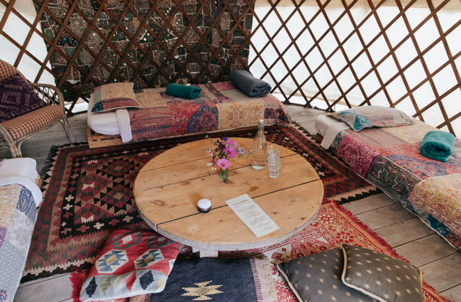 A seating area inside a yurt at Okuti Garden in Little River.