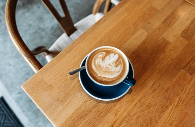 A close up of a flat white on a table.