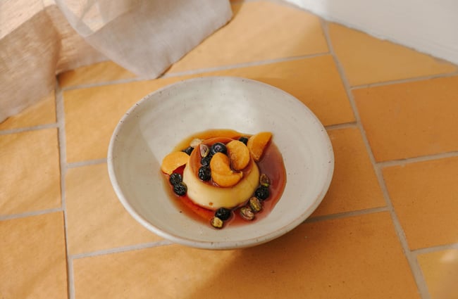 A Mexican dessert with custard, mandarins and berries.