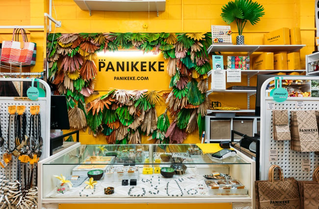 A Panikeke sign behind a shop counter.