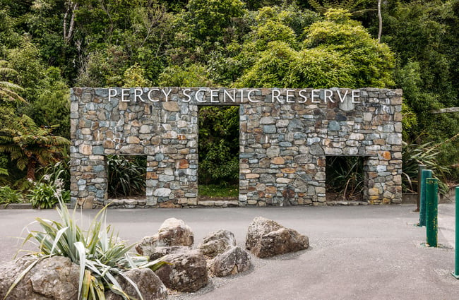 Stone wall with big sign above saying "Percy Scenic Reserve"