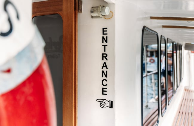 An 'Entrance' sign on a boat.