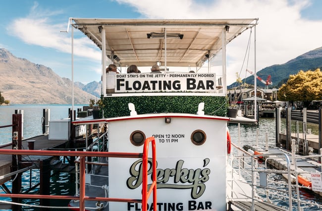 A 'floating bar' sign on a boat.
