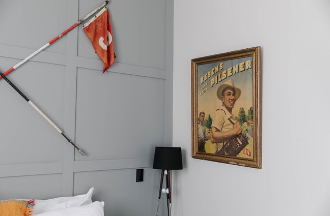 Close up of room interior with flag and framed picture at Poshtel in Ōamaru.