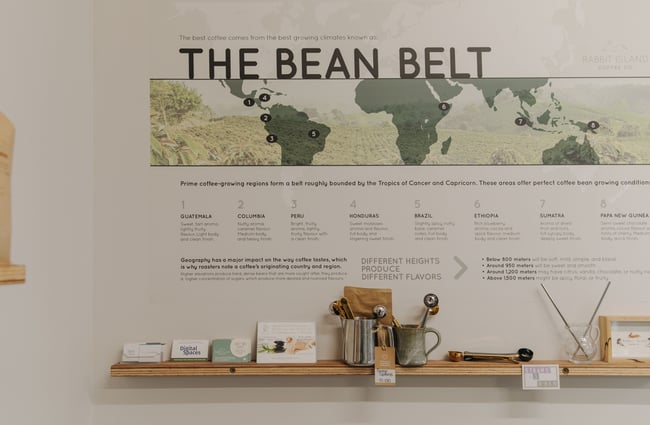 A green map on the wall highlighting where different coffee beans are from.