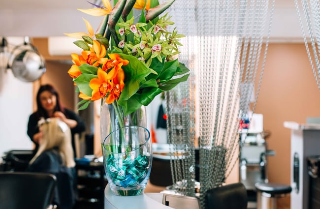 Large vibrant flower arrangement on silver counter.