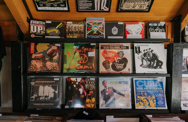 Records for sale hanging on the wall at Ride On Super Sound.