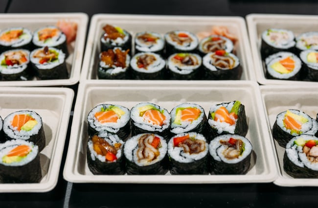 A close up of sushi in trays.