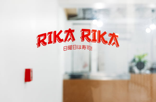 A 'Rika Rika' sign on a window.