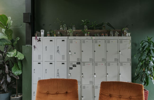 Old silver storage unit against a green wall.