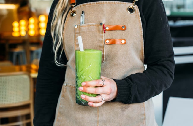 Person holding green smoothie at  Sentinel Cafe in Hamilton.