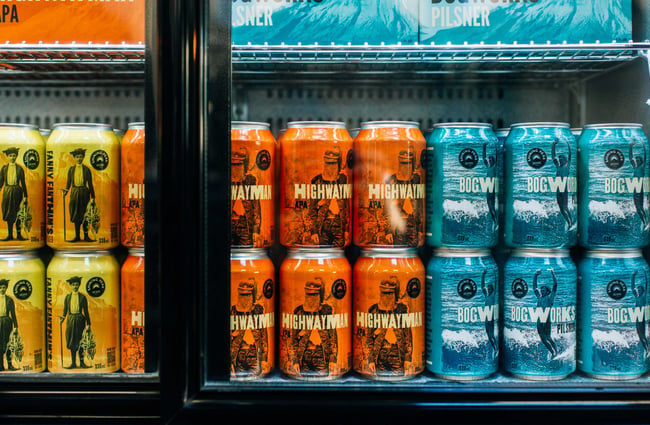 Close up of cans of beers in a fridge.