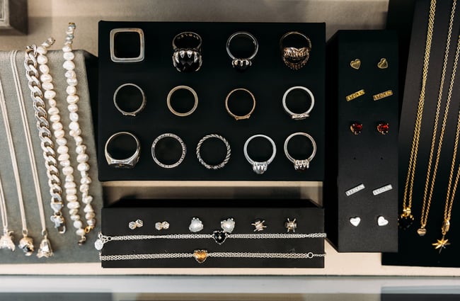 Silver and gold jewellery displayed in a black jewellery box with a velvet lining at Sisters on London, Hamilton.