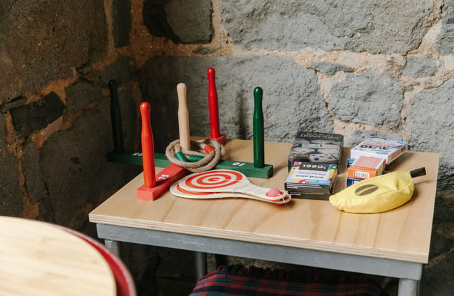 Games on a small side table inside Steamer Basin Dunedin.