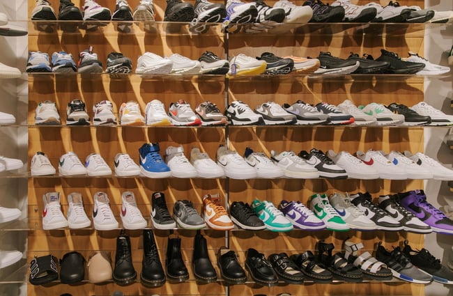 Shoes neatly lined up on shelves inside Stencil.